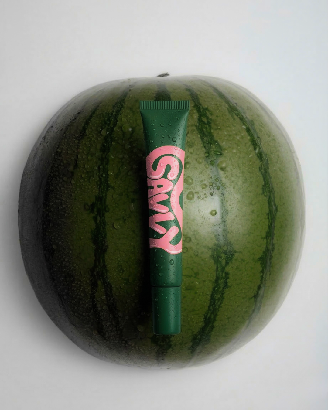 Savvy Body Glue tube on a watermelon
