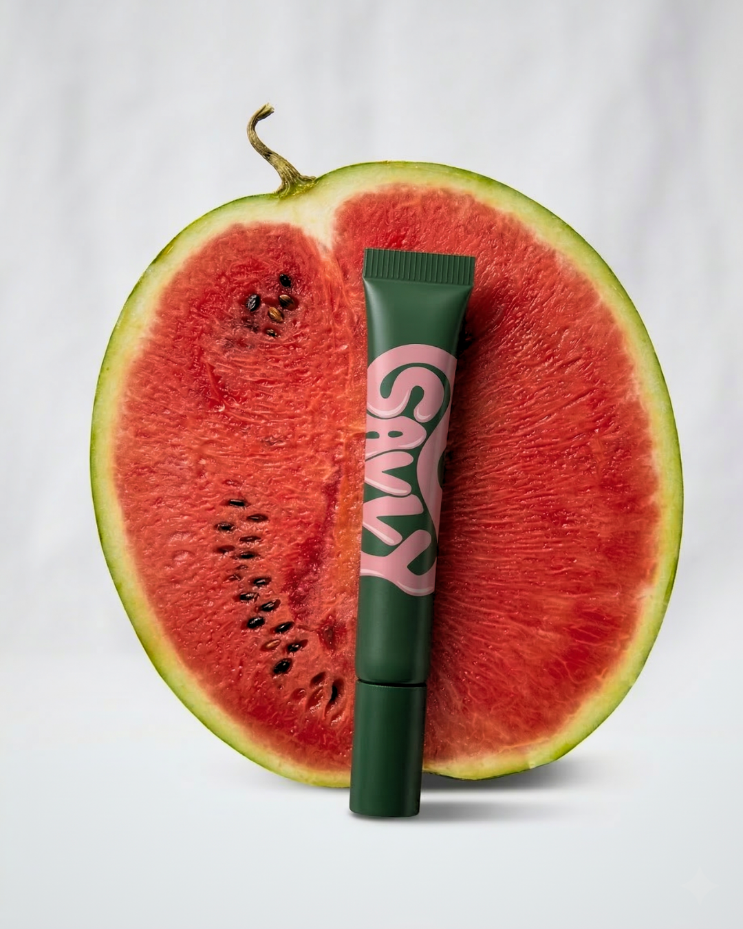 Savvy Body Glue tube against a halved watermelon